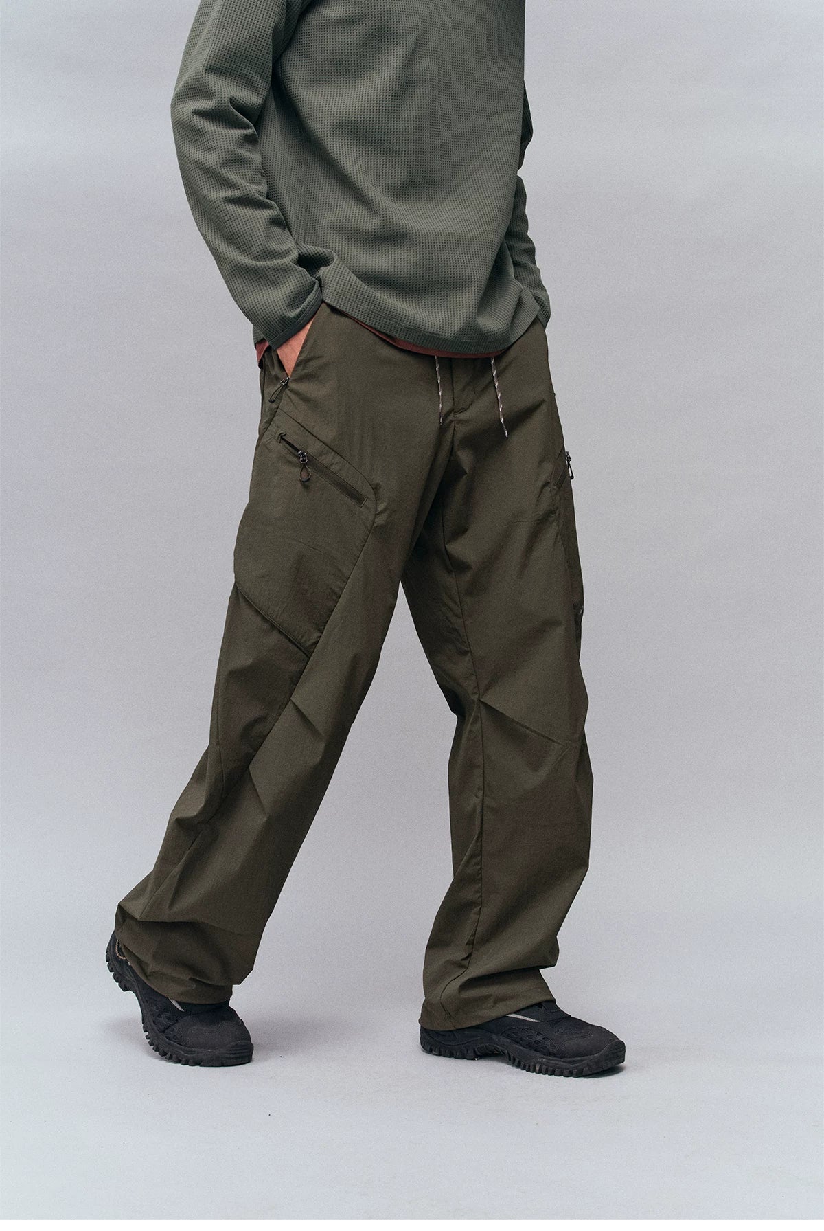 Unisex Water-Repellent Multi-Pocket Drawstring Utility Pants — worn by a model