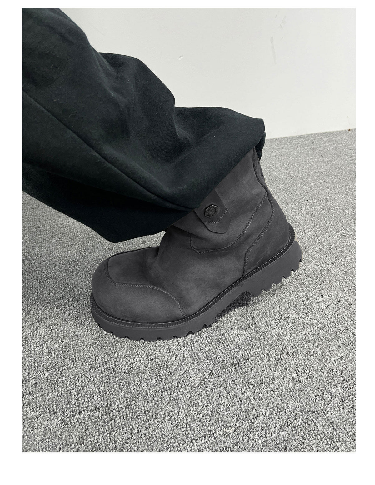 Gray suede winter boot worn with dark trousers, side view