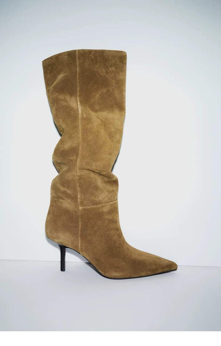 Khaki pointed-toe stiletto knee-high boot worn on the leg, side view