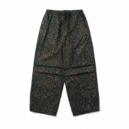 Moss green leopard print parachute pants with pleated knees and drawstring waist