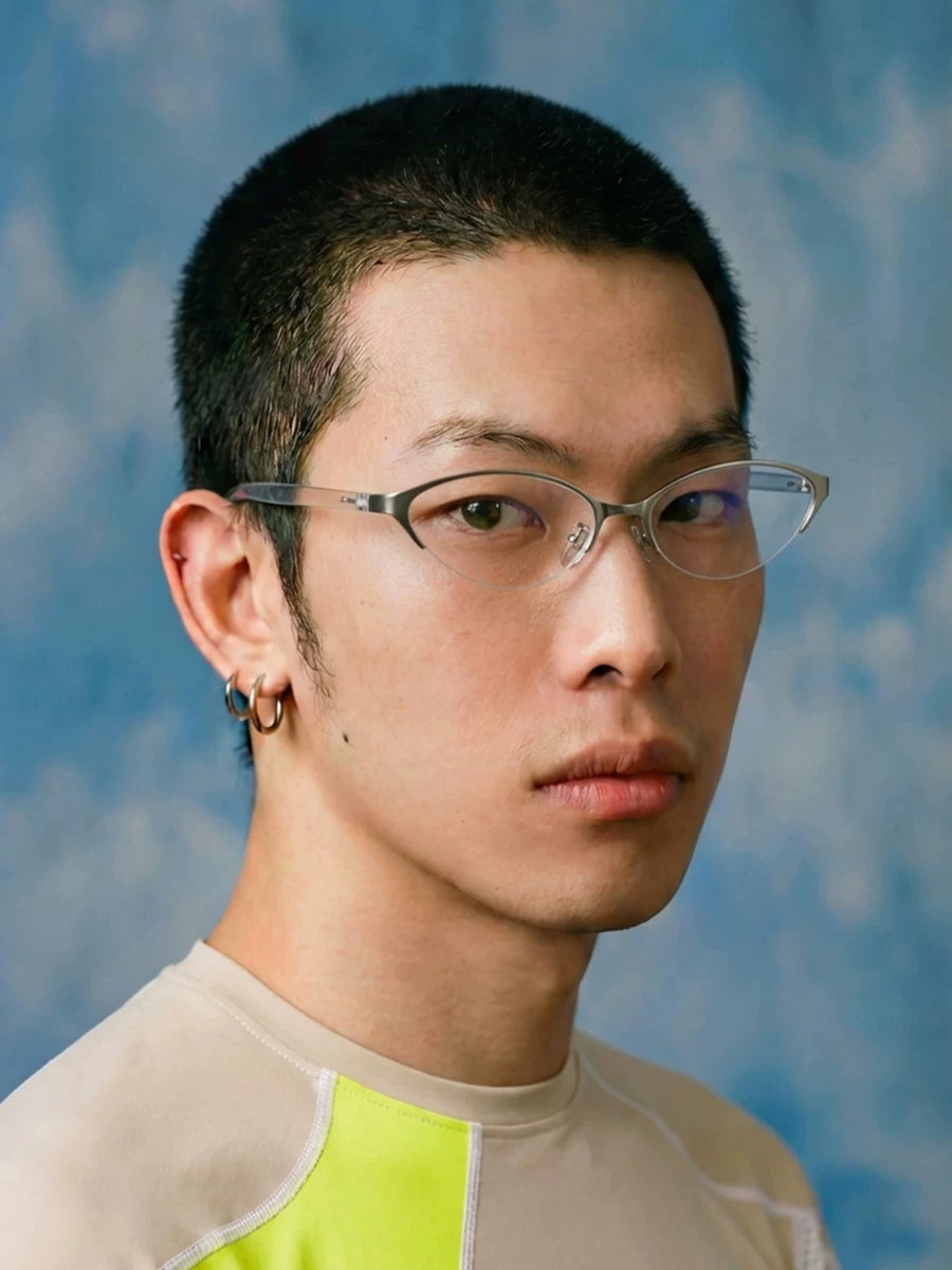 Metal Cat-Eye Sunglasses — Model wearing silver-tone cat-eye glasses against blue background