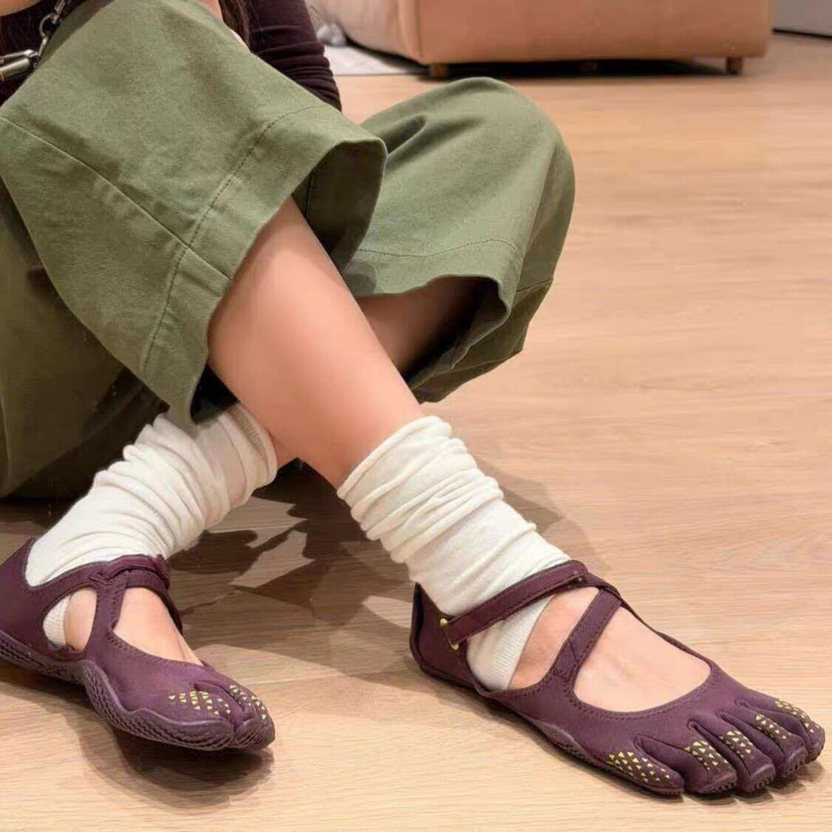 Purple FiveFingers V-Soul shoes worn with white socks and olive pants