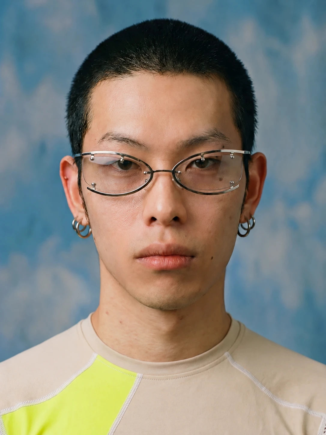 Model wearing silver Retro Rectangular Metal Glasses with clear lenses against a blue background