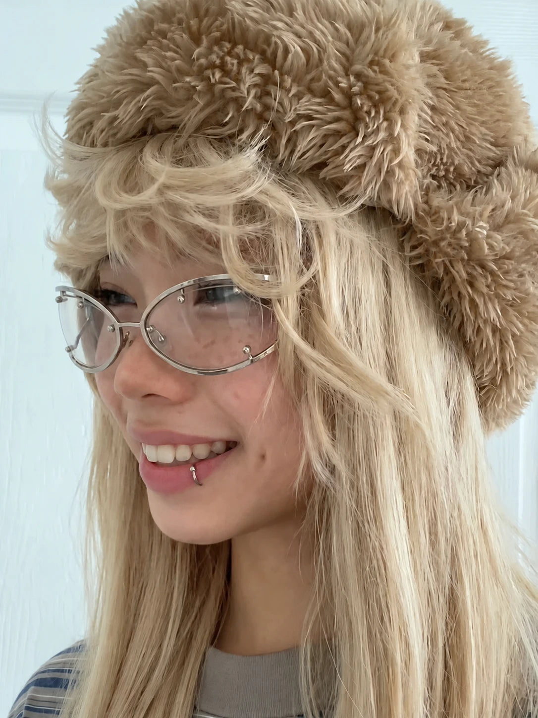 Side view of a model wearing silver Retro Rectangular Metal Glasses and a brown furry hat