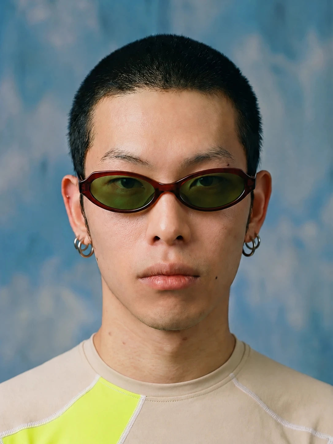 Retro Small-Square Sunglasses — Model wearing burgundy frame with green lenses, front view