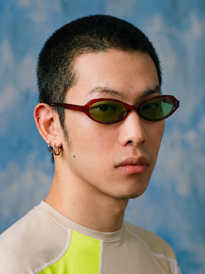Retro Small-Square Sunglasses — Model wearing burgundy frame with green lenses, three-quarter view
