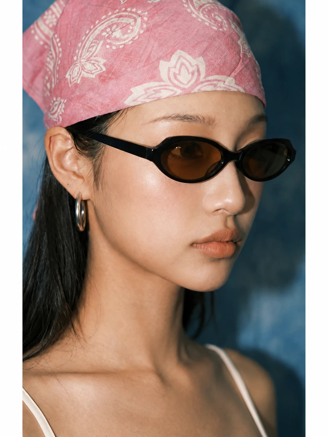 Retro Small-Square Sunglasses — Model wearing dark sunglasses with pink bandana, side view