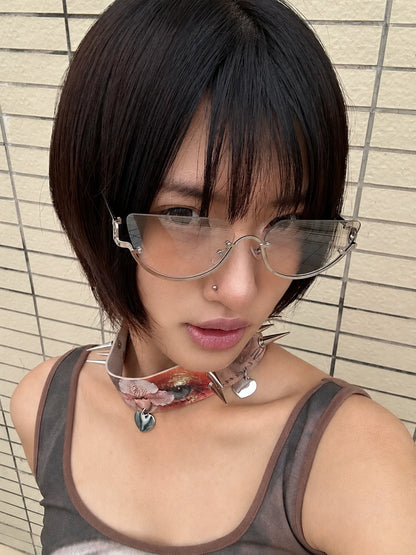 Model wearing silver-tone rounded aviator sunglasses with gradient lenses in front of a tiled wall.