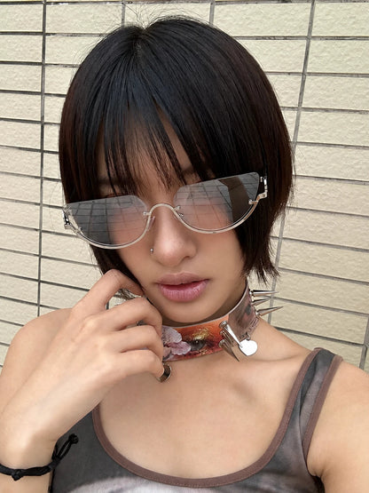 Model wearing silver-tone rounded aviator sunglasses with gradient lenses, with one hand beside the face.