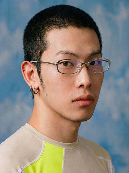 Slim Rectangular Metal-Frame Glasses — Model wearing clear-lens glasses against blue background