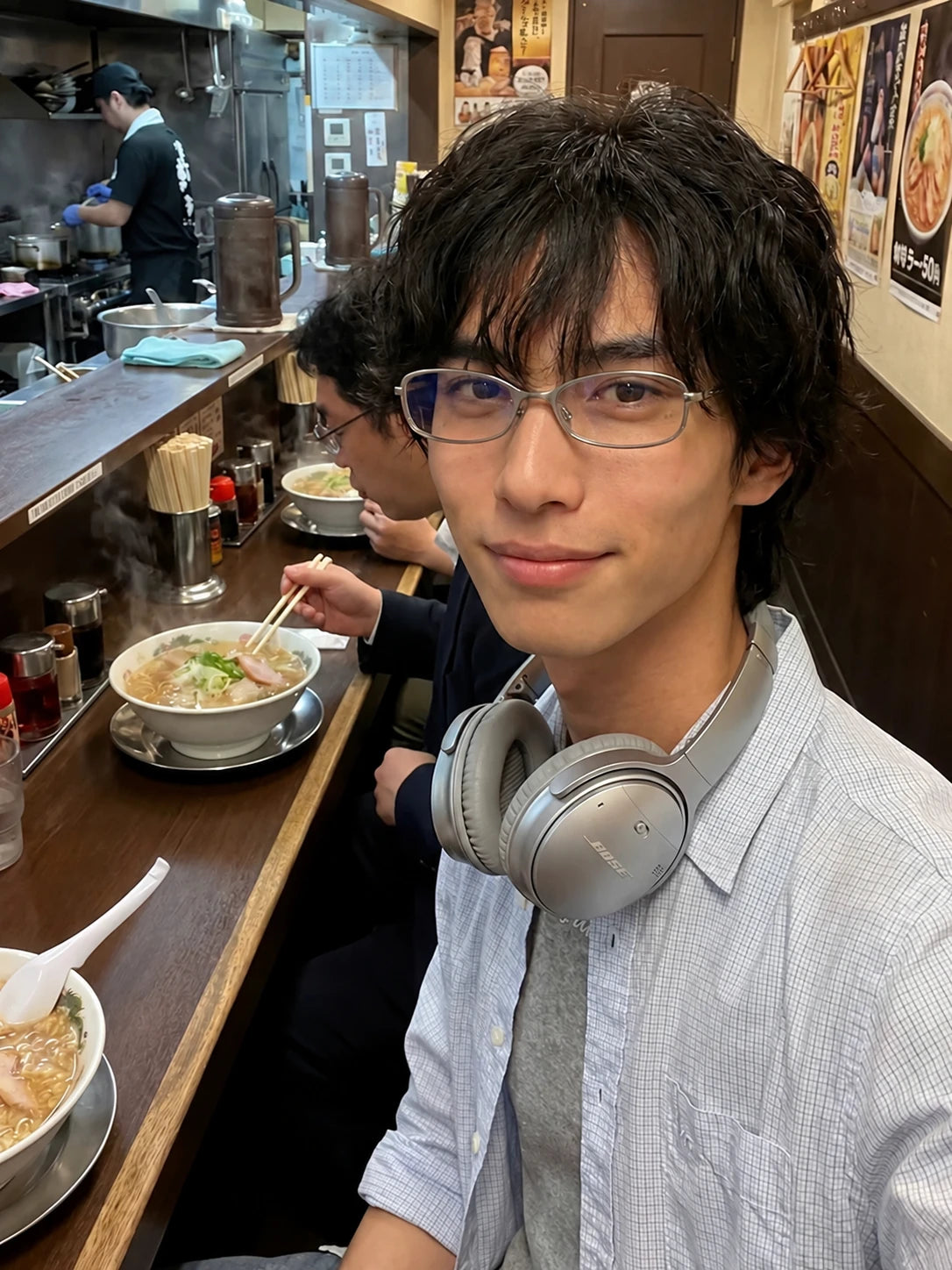 Slim Rectangular Metal-Frame Glasses — Model wearing clear-lens glasses in restaurant