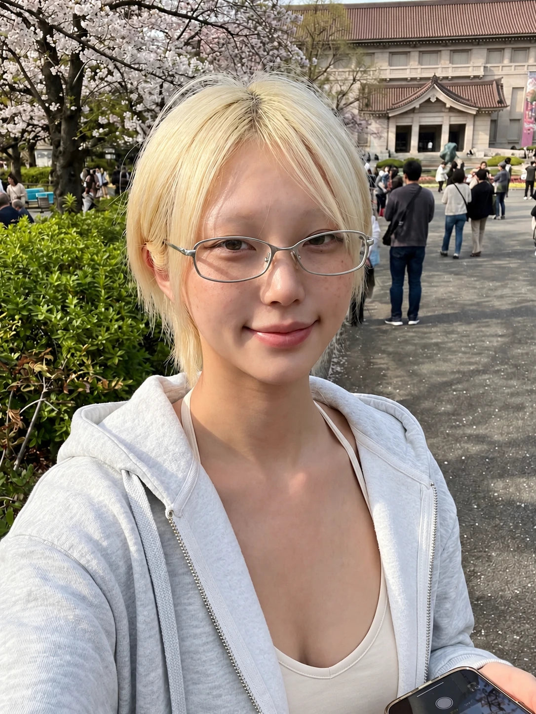 Slim Rectangular Metal-Frame Glasses — Model wearing clear-lens glasses outdoors
