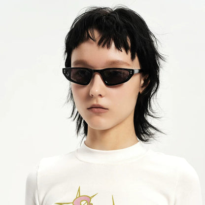 Petites lunettes de soleil triangulaires — coloris noir ; porté