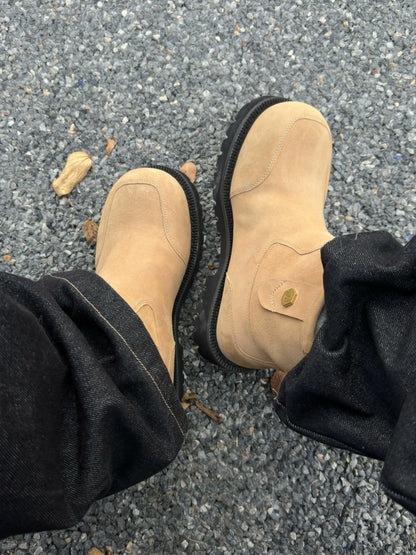 Tan suede winter boots worn with black trousers, top view