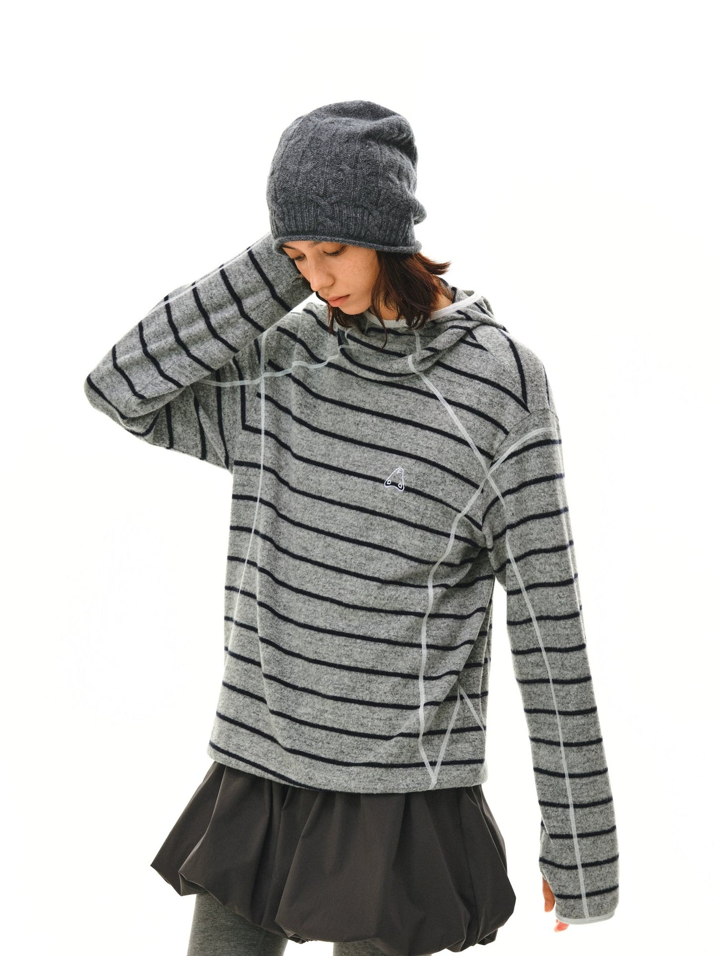 The EastLyst Textured Stripe Knit Hoodie, featuring black horizontal stripes and white seam details in a relaxed fit, is displayed laid flat on a white background.