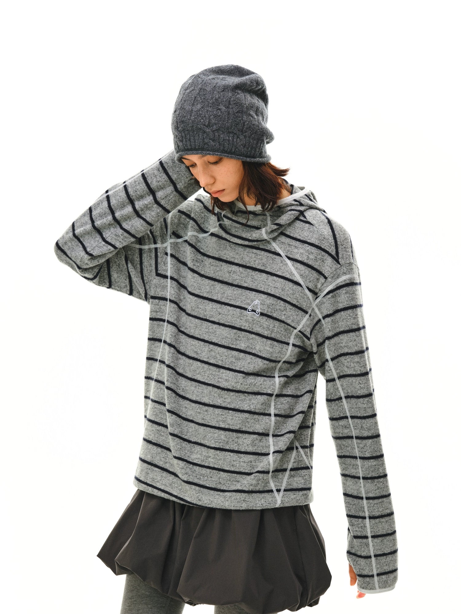 The EastLyst Textured Stripe Knit Hoodie, featuring black horizontal stripes and white seam details in a relaxed fit, is displayed laid flat on a white background.