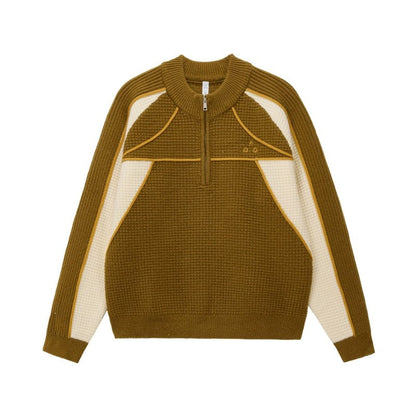 The EastLyst Color Block Half Zip Sweater features a navy and white geometric design with blue accents, long sleeves, a textured knit, and premium warmth—perfect for autumn and winter.