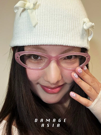 Upswept Cat-Eye Clear-Lens Glasses — Model wearing pink clear-lens cat-eye glasses with knit hat, front view