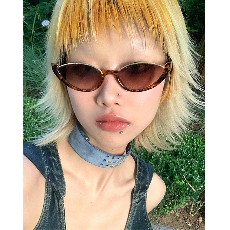 Upswept Cat-Eye Tinted Sunglasses — Model wearing cat-eye sunglasses outdoors