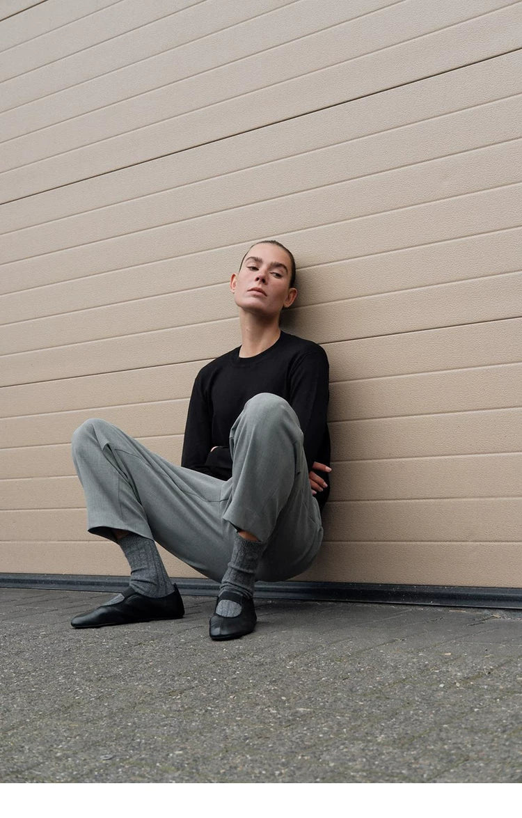 Women's Low-Heel Mary Jane Ballet Flats — model wearing black flats, seated