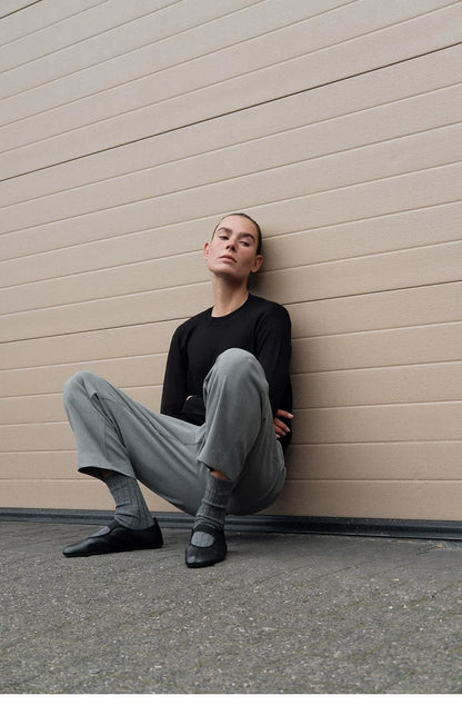Women's Low-Heel Mary Jane Ballet Flats — model wearing black flats, seated
