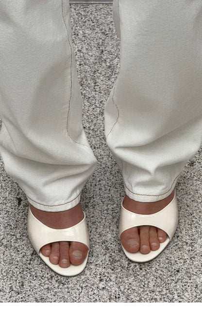Women's Stiletto Heel Mule Slide Sandals — cream mules worn with white trousers