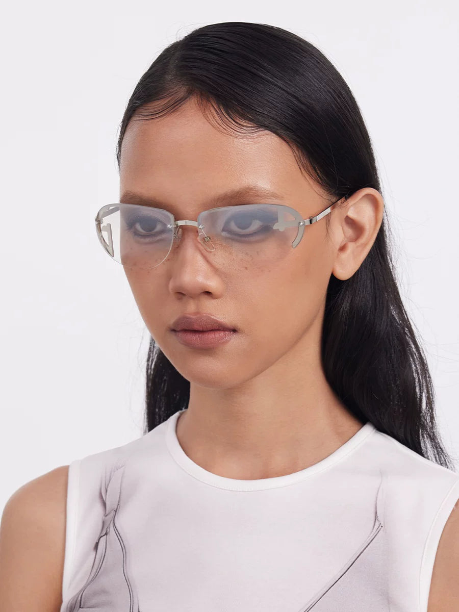 Y2K Rimless Tinted Sunglasses — Model wearing rimless glasses with light lenses