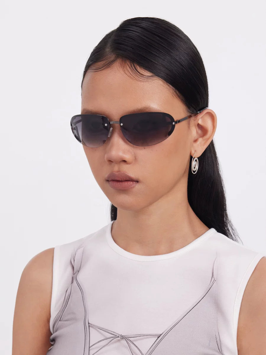 Y2K Rimless Tinted Sunglasses — Model wearing rimless sunglasses with dark lenses